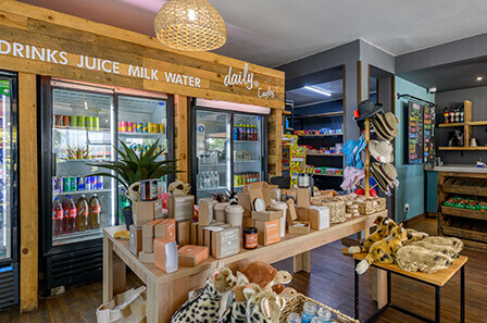 The interior of the Daily@Cayley store. Various items are on display, including hats, drinks and soft toys