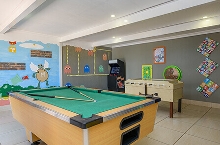 The games room with the pool table, soccer table and arcade machine in view