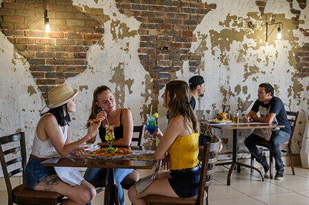 3 ladies sitting drinking cocktails whilst enjoying a meal in the restaurant.